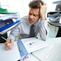accountant overwhelmed by files and reports