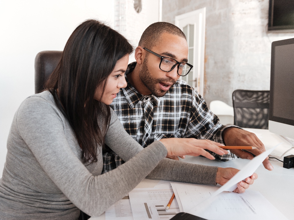 business couple at PC/desk with documents